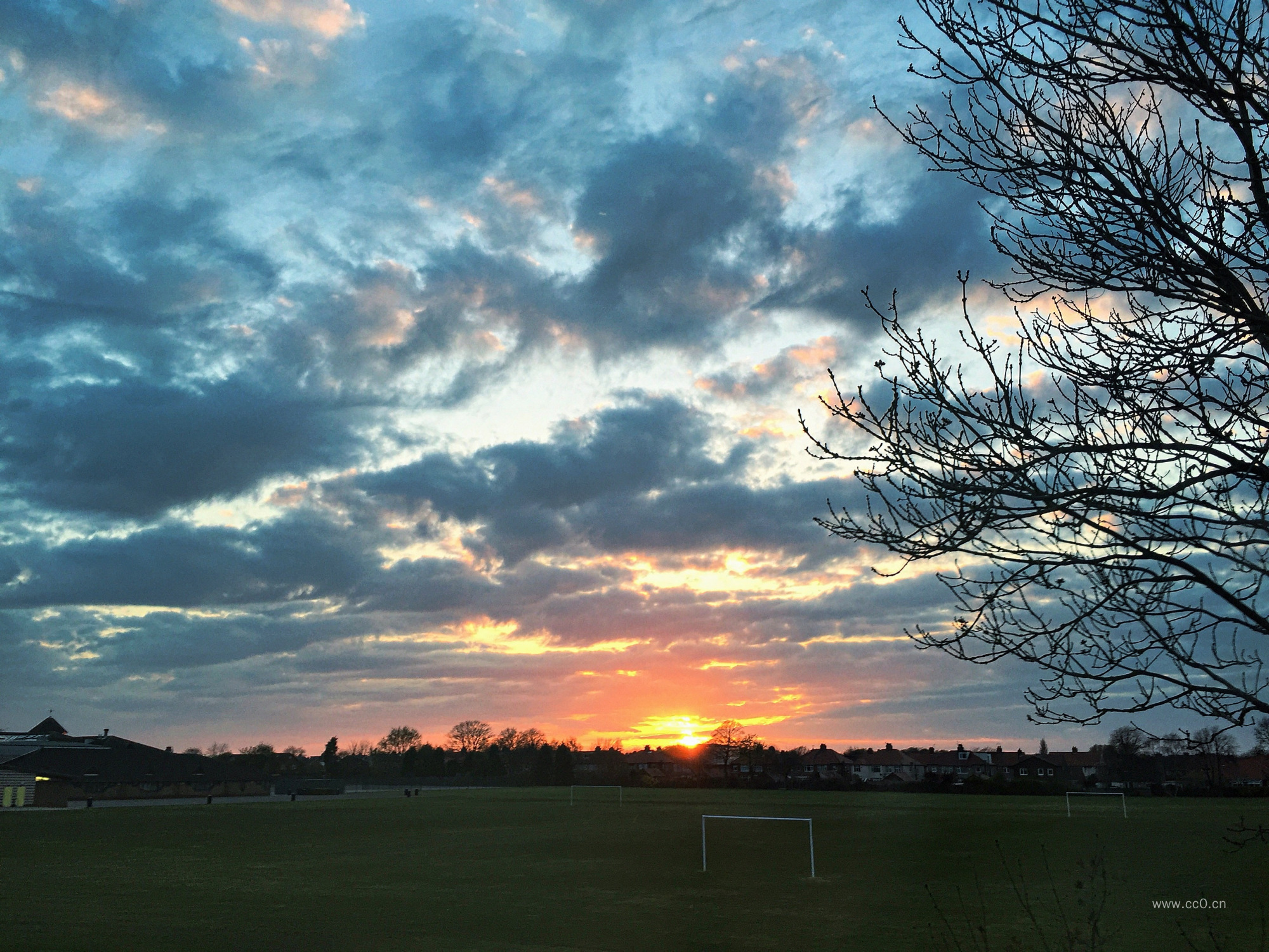 日出天空与足球场的草坪